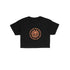 A black short-sleeve crop top t-shirt featuring a circular orange graphic on the chest with a skull inside a sun and the text &