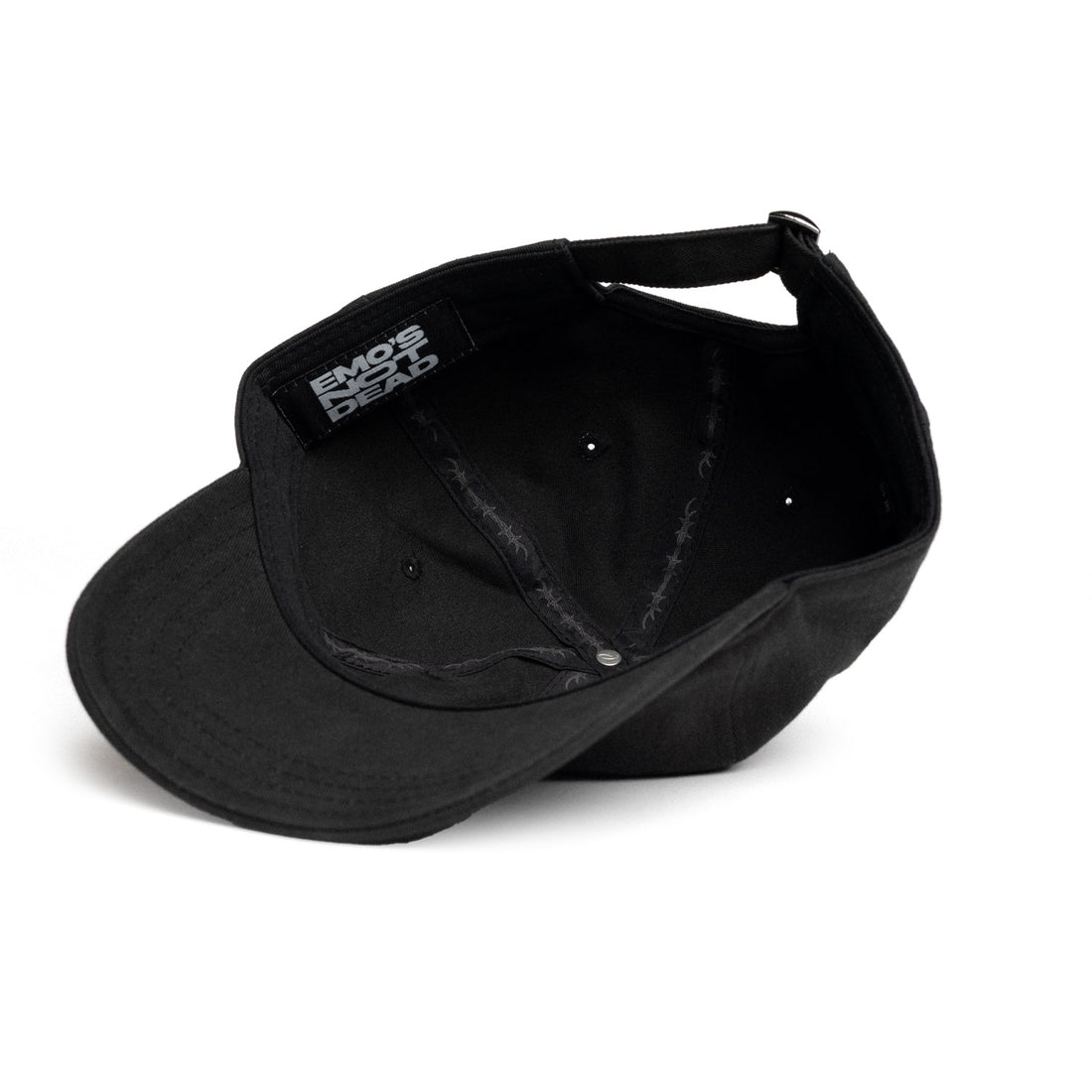 A black baseball cap shown from an angled top-down view, featuring a black fabric patch on the side with the white text &