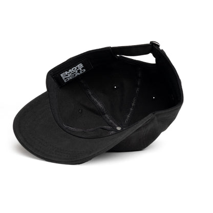 A black baseball cap shown from an angled top-down view, featuring a black fabric patch on the side with the white text &